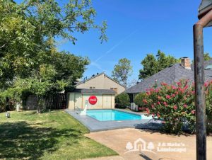 Norman home with an outdoor space featuring a pool and lush green lawn